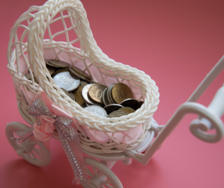 White baby carriage with coins in it